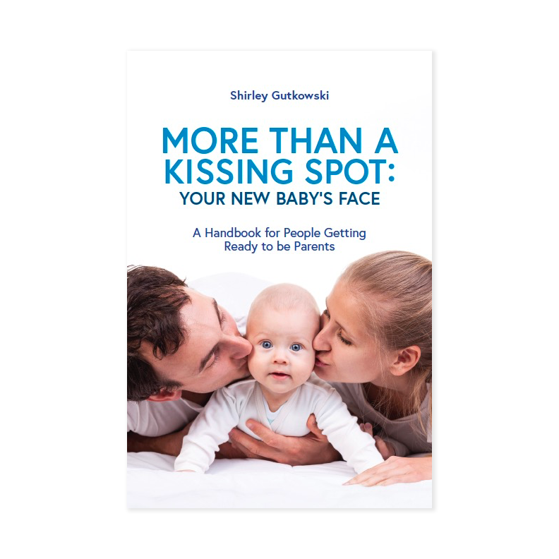Book cover of 'More Than a Kissing Spot: Your New Baby's Face' by Shirley Gutkowski, showing a couple kissing a baby.