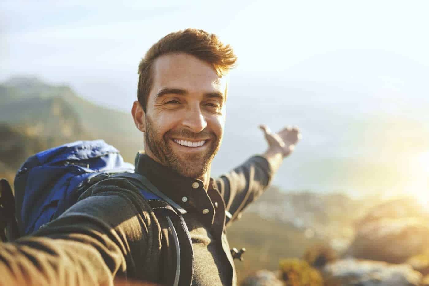 man on hike smiling at camera