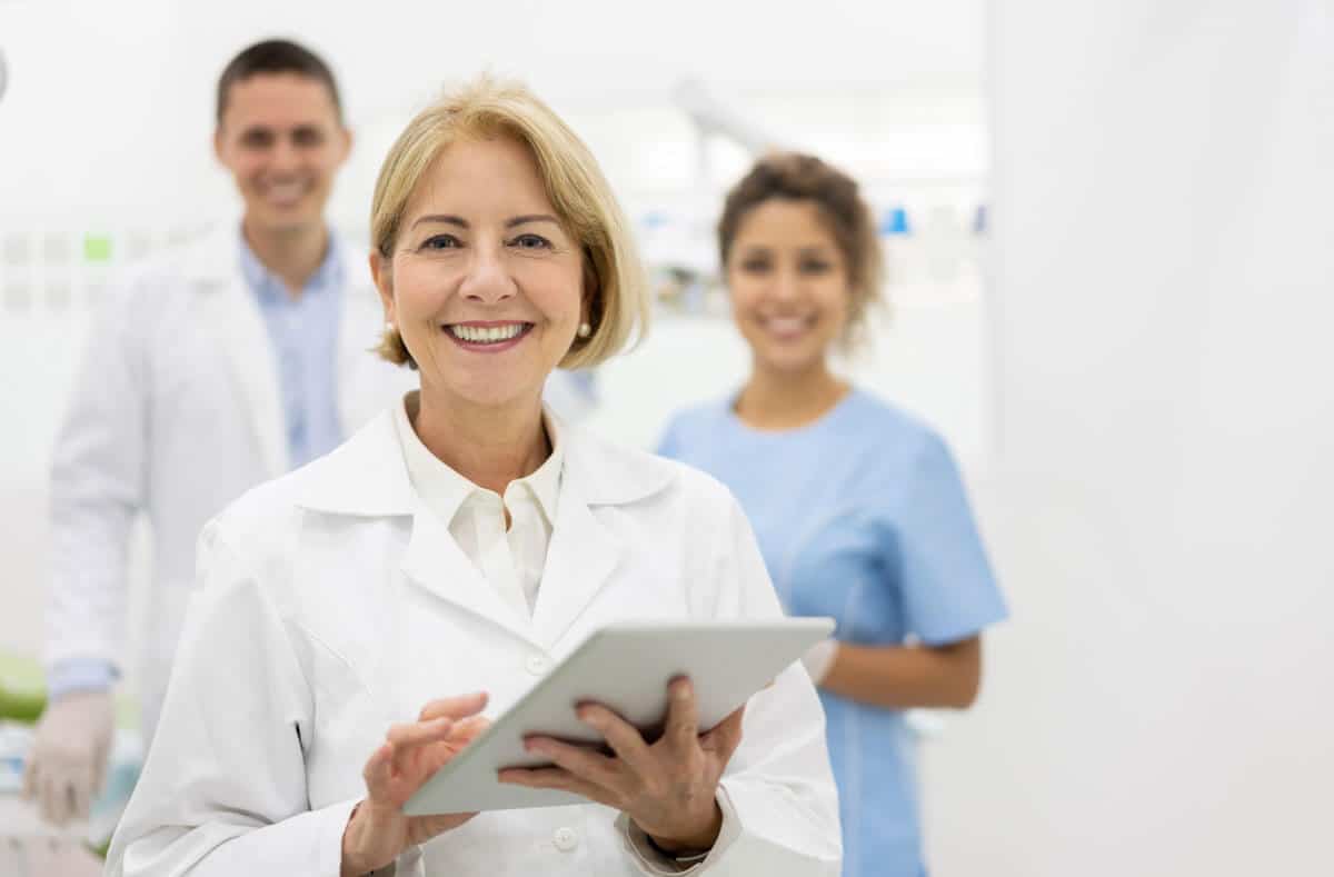 happy smiling female doctor holding tablet