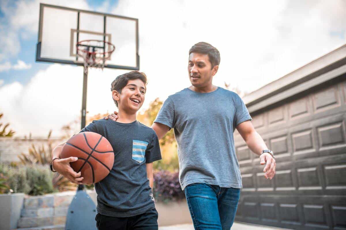 father and son playing basketball